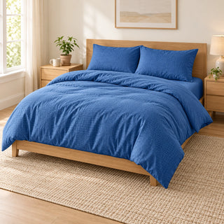 Blue embossed microfiber bed sheet set with duvet cover, fitted sheet, and matching pillowcases